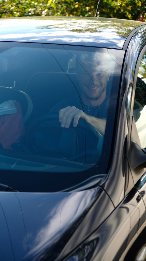 Happy driver in a scratched rental car